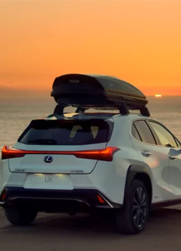 Voiture Lexus devant la mer et un coucher de soleil