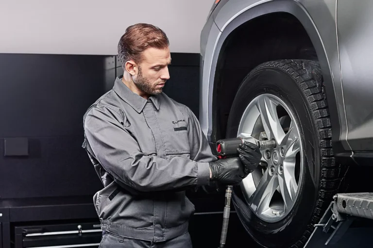 Homme qui change un pneu Lexus